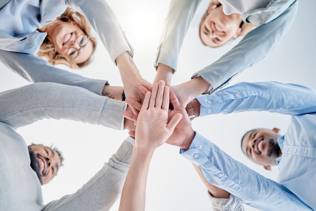 Hands together, support and teamwork people for collaboration success, staff mission and business solidarity. Happy group of employees stacked sign for goals, community and diversity in below mockup.